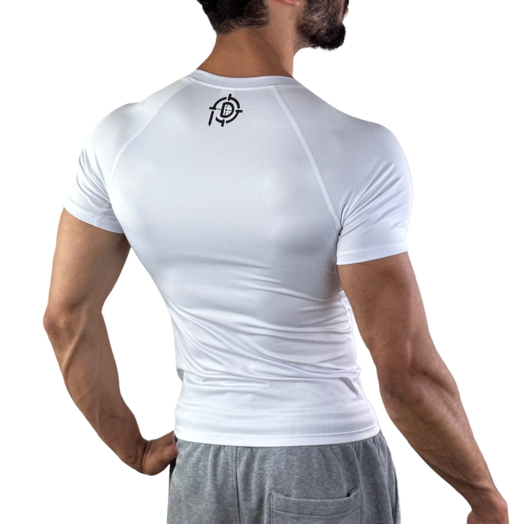 Man wearing a tight-fit white compression shirt showing the back view with a black Pludyna logo near the neckline.