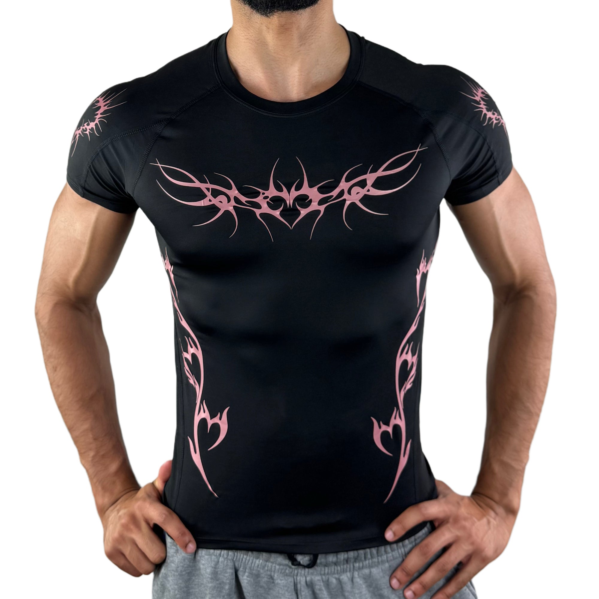 Front view of fitted black gym shirt with symmetrical pink tribal heart designs on chest and torso