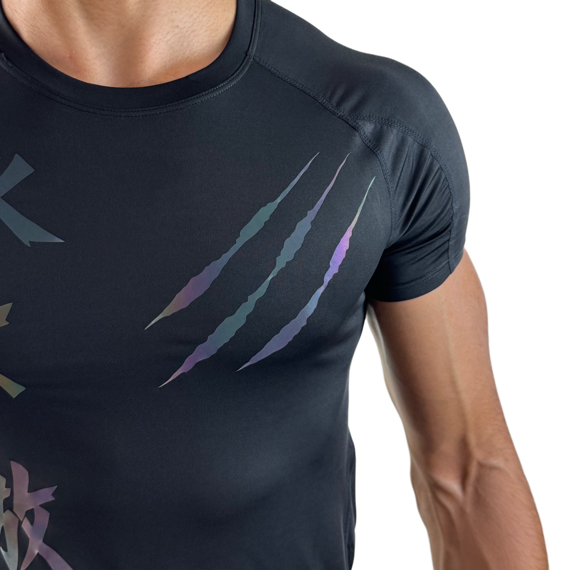 Close-up of a black athletic shirt featuring colorful claw mark accents and stylized text on the chest, displayed against a white background