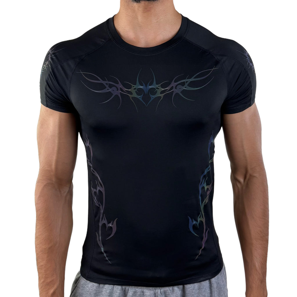 Men’s black compression shirt with iridescent tribal design, front view under low lighting.