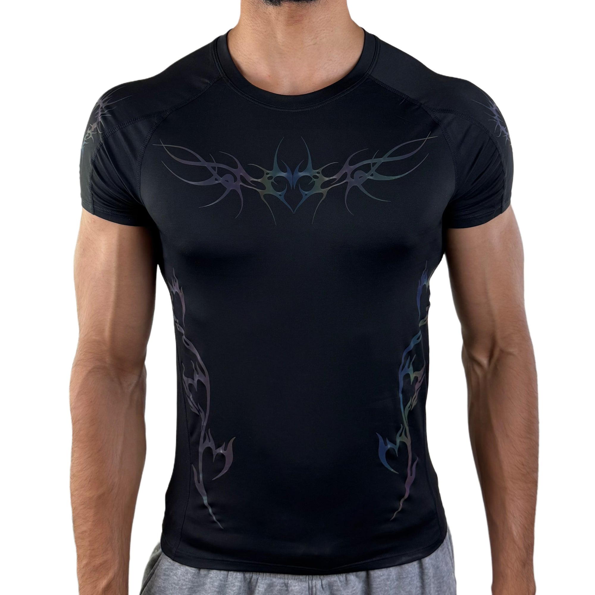 Men’s black compression shirt with iridescent tribal design, front view under low lighting.