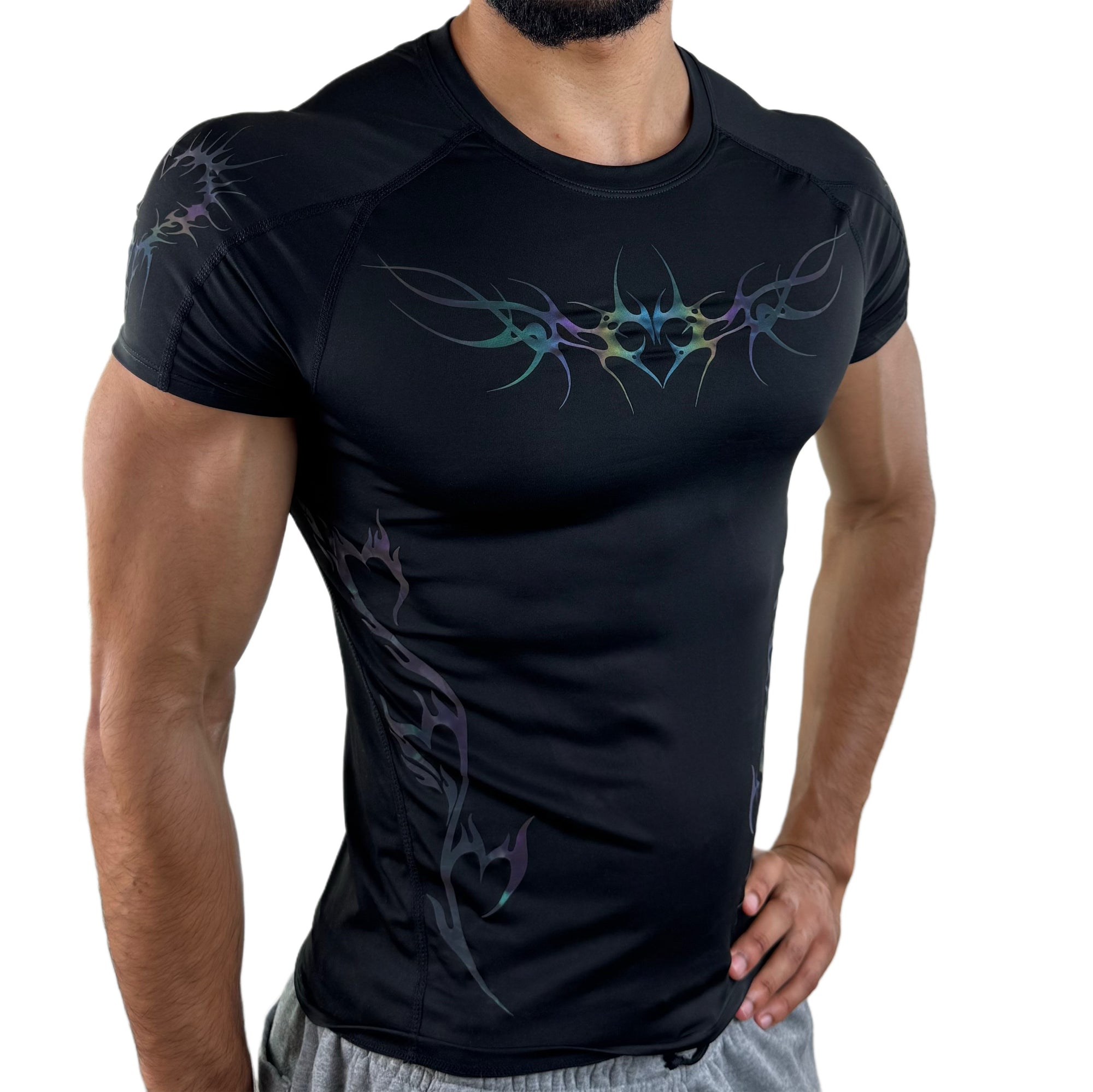Men’s black compression shirt with iridescent tribal design, side view under low lighting.