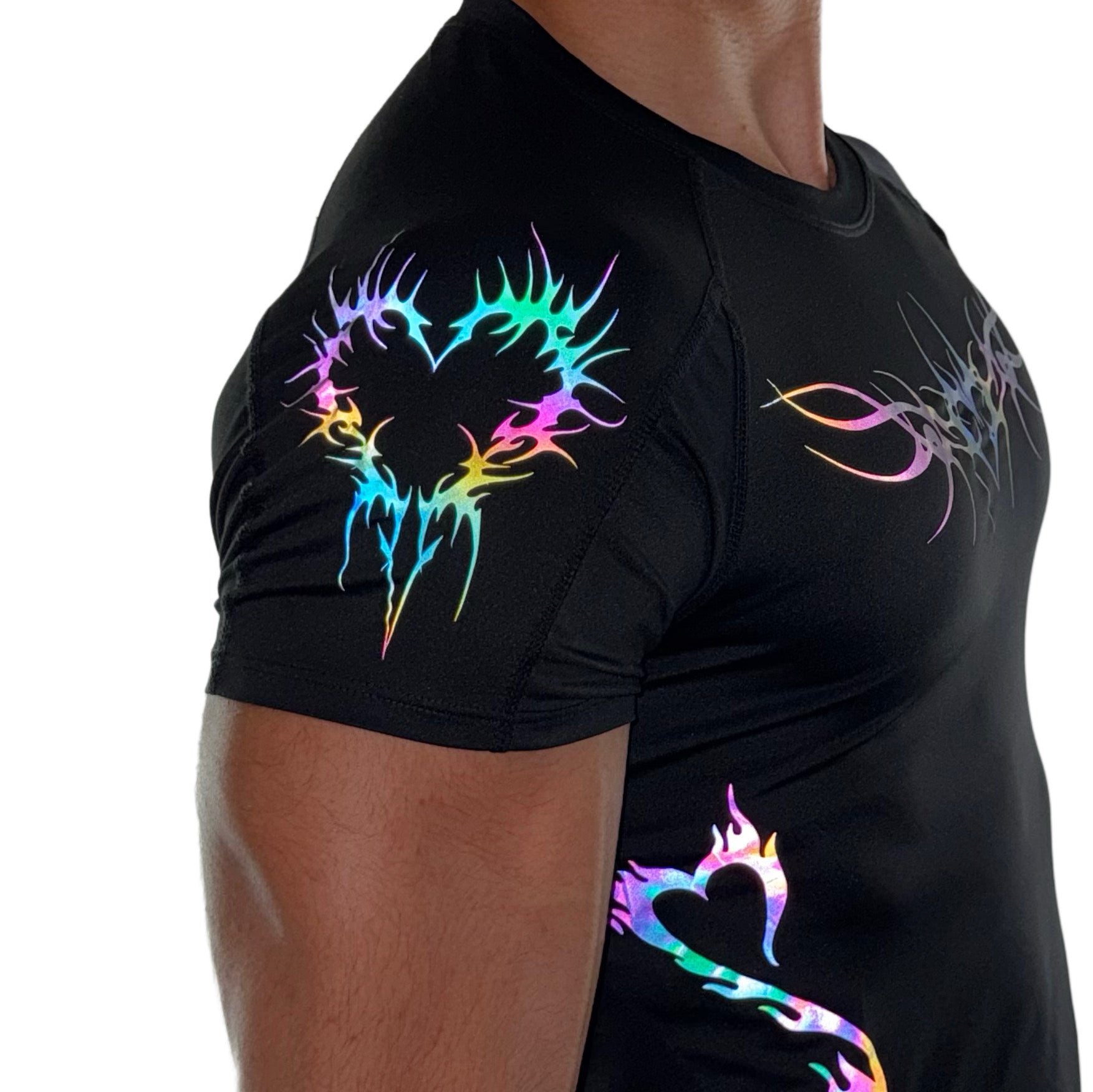 Side view of black men’s compression shirt with rainbow reflective heart and tribal flame designs on the shoulder and waist.