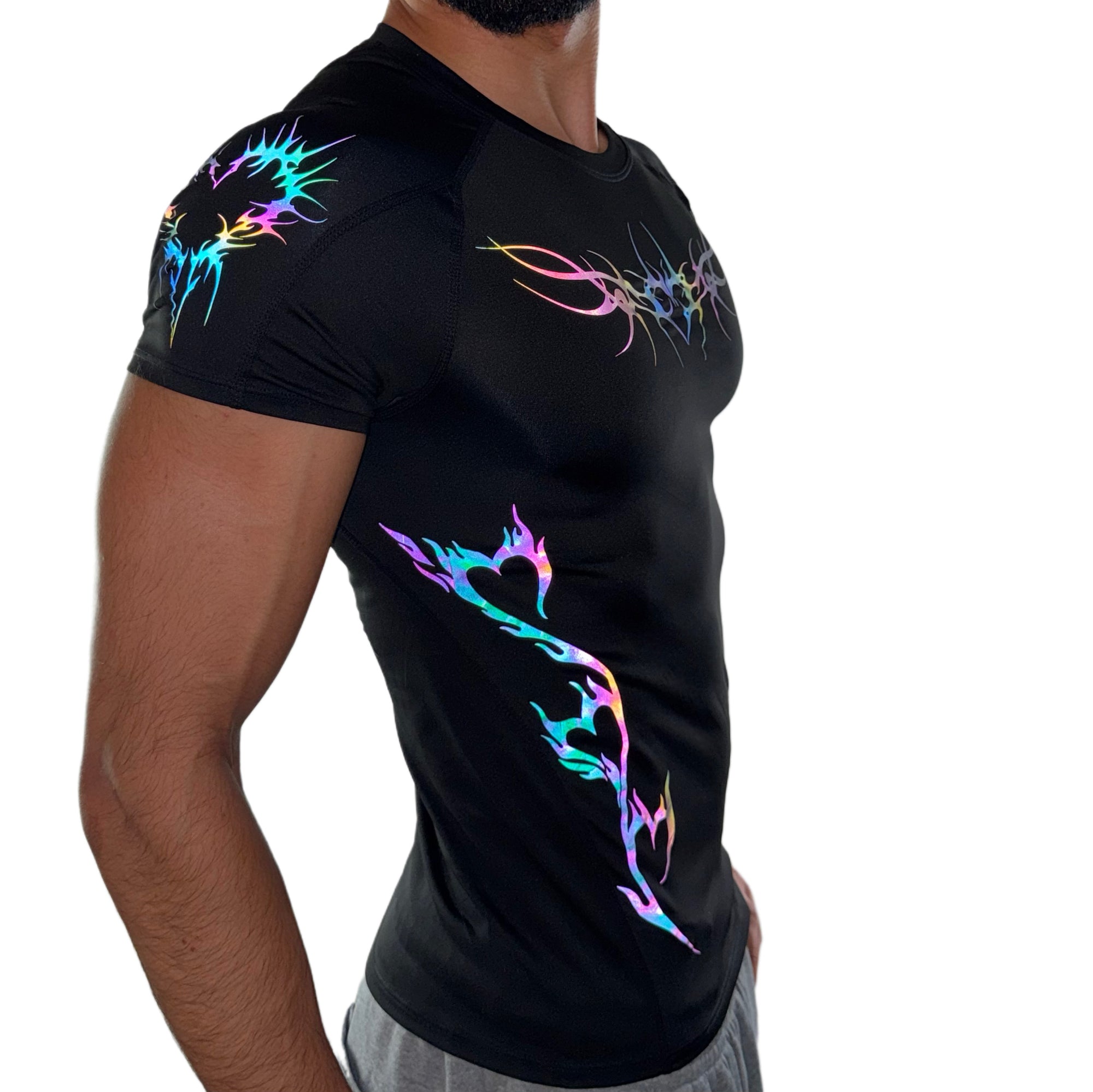 Side profile of men’s black performance shirt with rainbow reflective tribal heart graphics on the shoulder and side waist.
